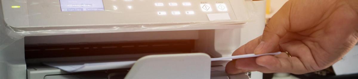 Business Documents concept: Businesswoman hands removing documents from document scanner tray