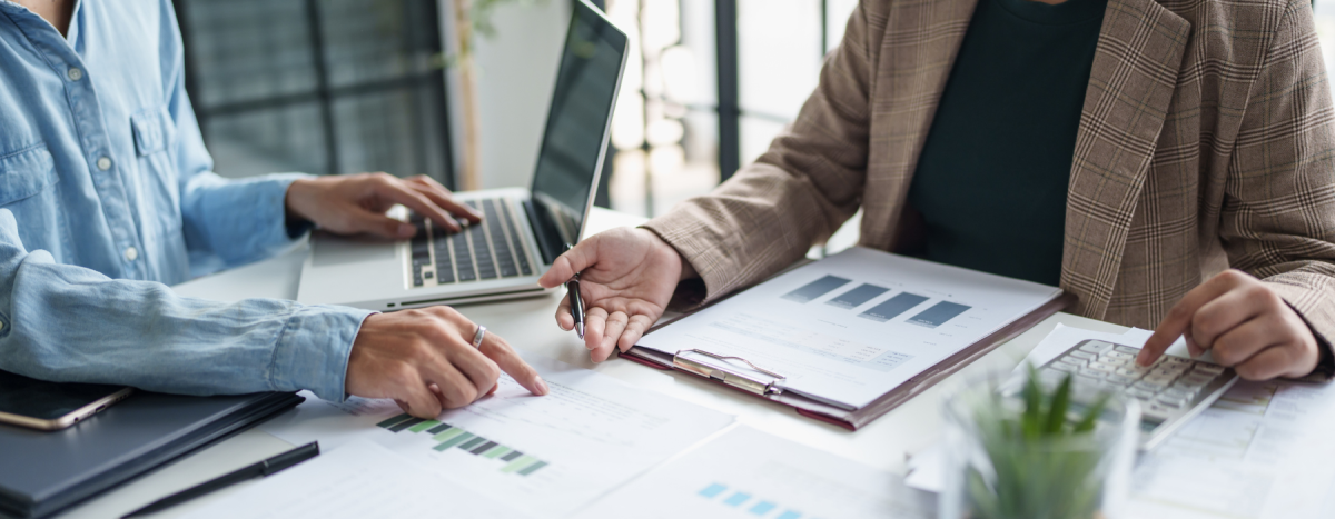 accounts payable team working on paperwork looking at graphs
