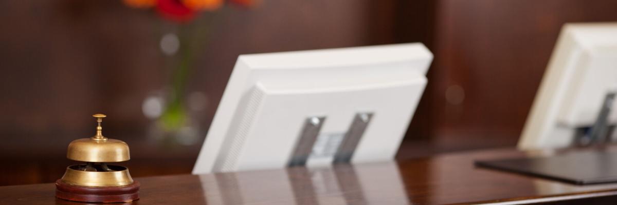 hotel counter with bell and computers