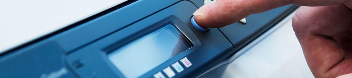 close-up of a hand pushing buttons on a printer, multifunction printer, managed print concept
