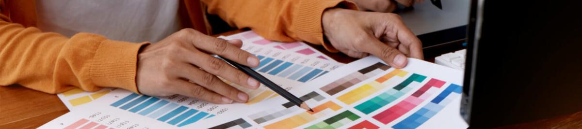 woman working with production print papers, choosing colors for production printer